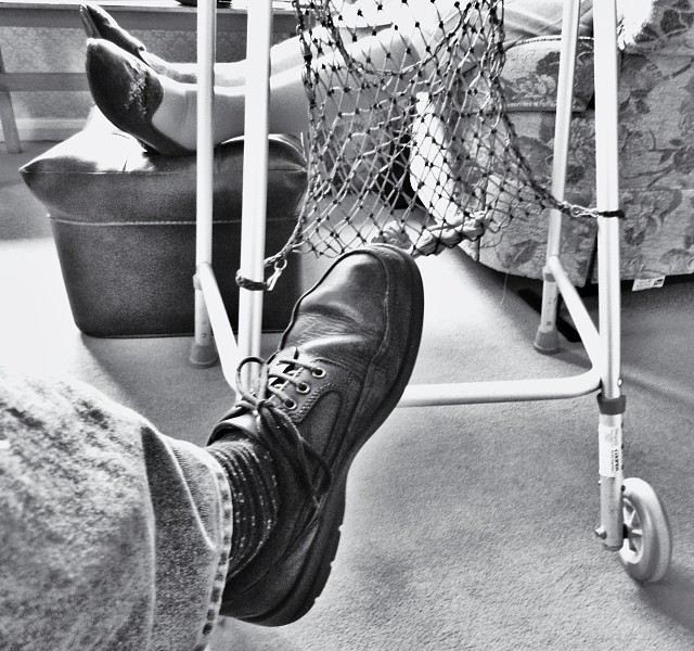 A man's foot with a old lady's feet in the background copyright Bernard Young